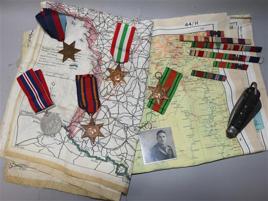 Two silk escape maps, Army Jack knife, five medals and medal bars and a military photo